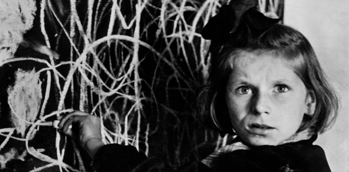 David Seymour, Tereska, a child in a residence for children. She drew a picture of "home" on the blackboard. Poland. 1948.© David Seymour / Magnum Photos